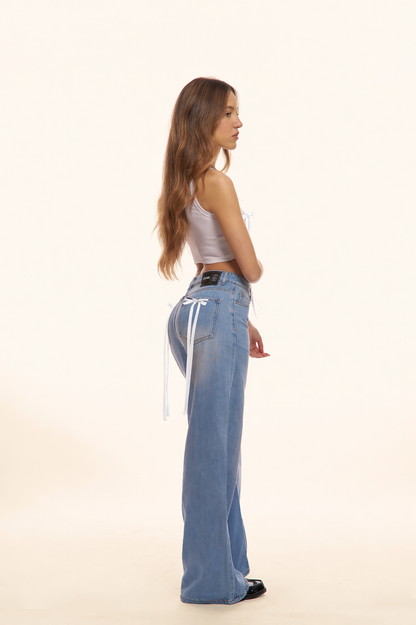 PANTALONI JEANS CON FIOCCHI BIANCHI