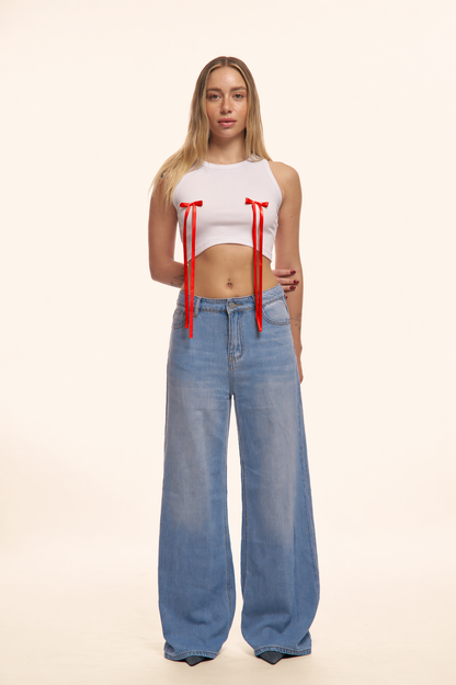 PANTALONI JEANS CON FIOCCHI ROSSI