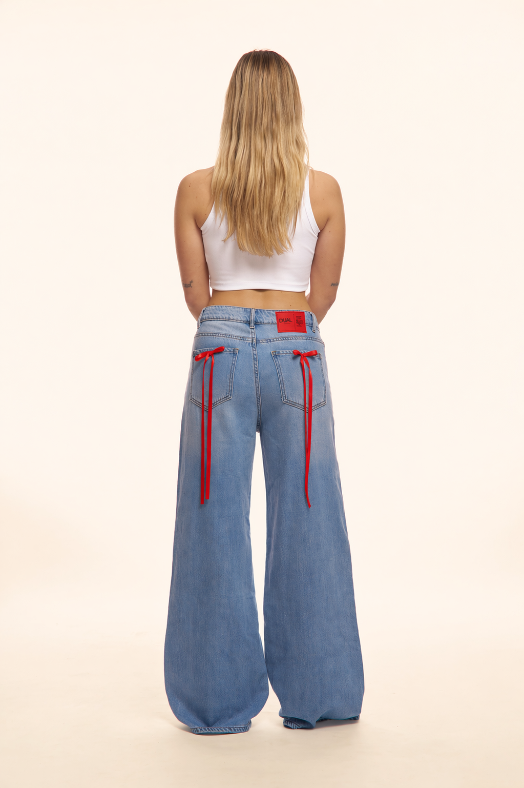 PANTALONI JEANS CON FIOCCHI ROSSI