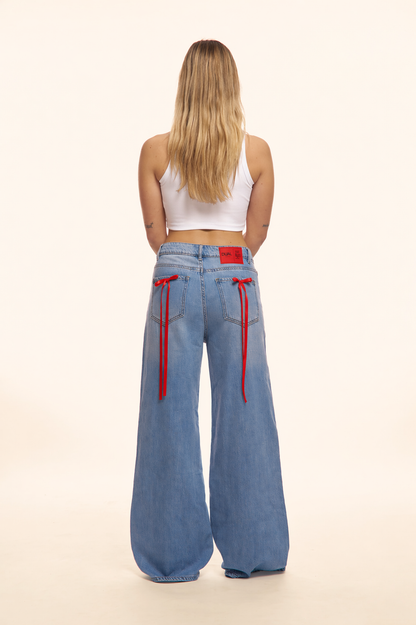 PANTALONI JEANS CON FIOCCHI ROSSI